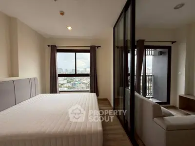 Spacious bedroom with city view and balcony access in modern apartment