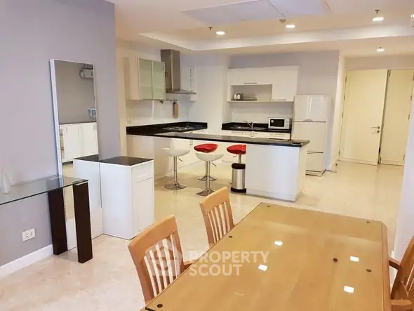 Spacious modern kitchen with open layout and dining area in a stylish apartment.