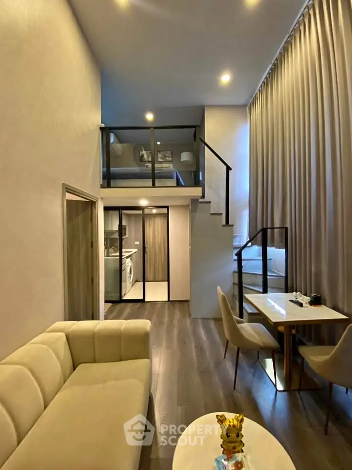 Modern loft apartment with high ceilings, cozy living area, and stylish mezzanine bedroom.