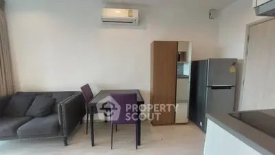 Modern living room with air conditioning, dining table, and sleek furniture.