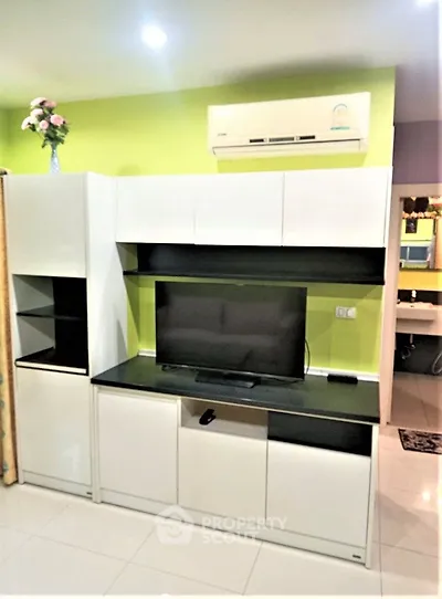 Modern living room with sleek entertainment center and air conditioning