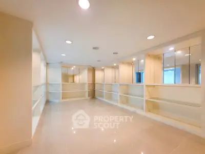 Spacious and bright storage room with built-in shelves and modern lighting.