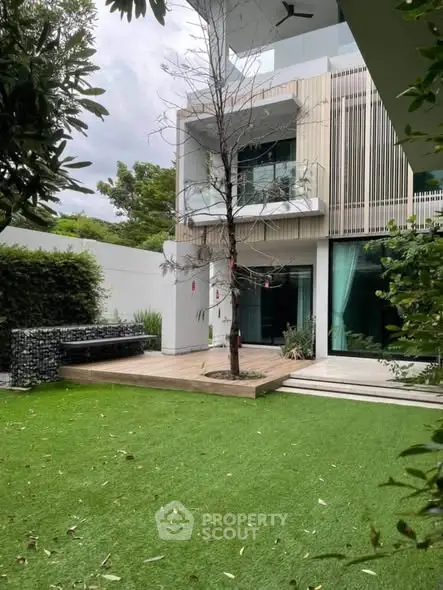 Modern luxury home with spacious garden and sleek architectural design.
