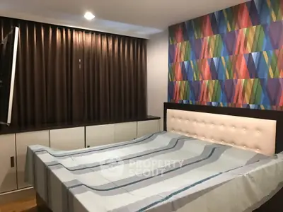 Stylish bedroom with colorful accent wall and modern furnishings