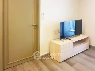 Modern living room with sleek TV stand and wooden flooring