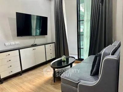 Modern living room with sleek furniture and large TV, featuring floor-to-ceiling windows and elegant decor.