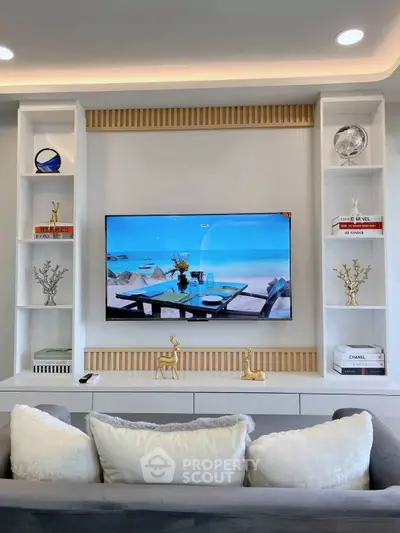 Stylish living room with modern TV setup and elegant decor accents.