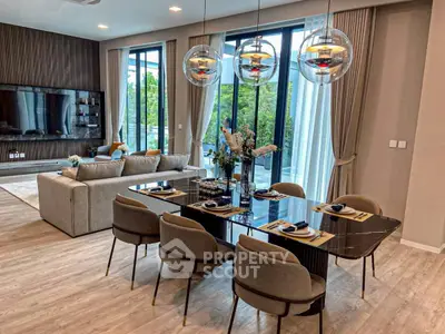 Luxurious open-plan living and dining area with modern decor and large windows.