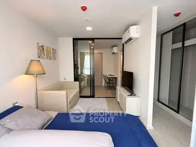 Modern studio apartment with open layout, featuring cozy living area and stylish bedroom.