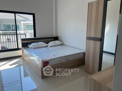 Modern bedroom with large window and stylish wooden furniture