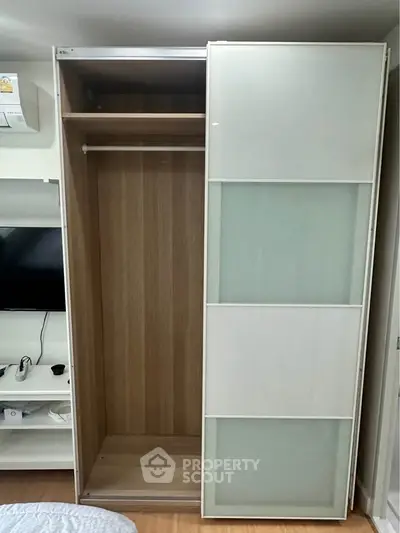 Modern wardrobe with sliding doors in a stylish bedroom setting.