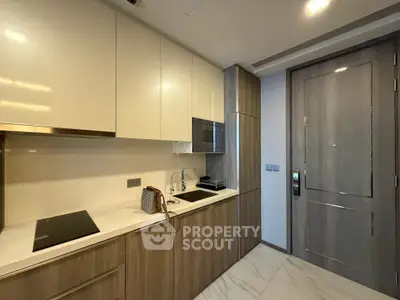 Modern kitchen with sleek cabinetry and built-in appliances in a stylish apartment.
