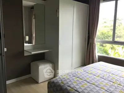 Cozy bedroom with modern decor and large window offering lush garden views.