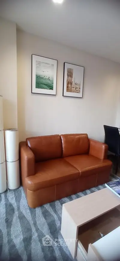 Modern living room with stylish brown leather sofa and elegant wall art