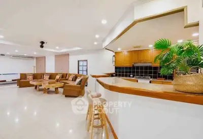Spacious open-plan living room with modern kitchen and stylish decor
