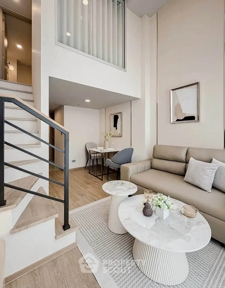 Modern duplex living room with stylish decor and elegant staircase