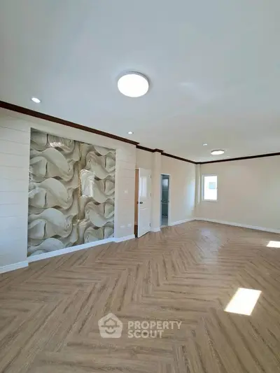 Spacious living room with elegant wood flooring and modern wall design