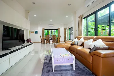 Spacious modern living room with large windows and elegant decor