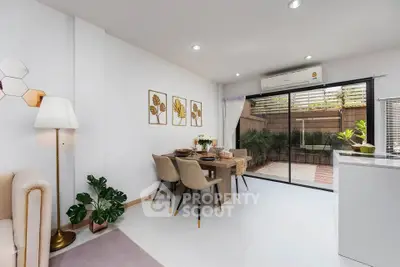 Modern dining area with elegant decor and garden view, featuring stylish furniture and natural light.