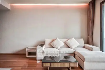 Modern living room with stylish sofa and elegant lighting, perfect for relaxation and entertaining.