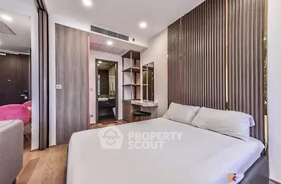 Modern bedroom with stylish decor and ensuite bathroom in luxury apartment