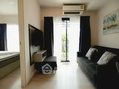 Modern living room with balcony access and stylish decor in a cozy apartment.