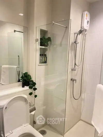 Modern bathroom with glass shower and sleek fixtures, ideal for contemporary living.