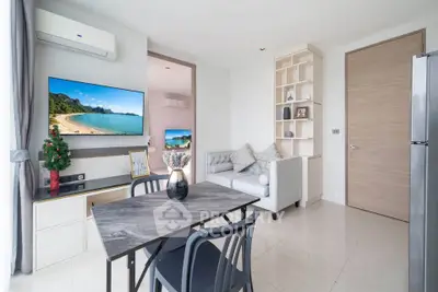 Modern living room with stylish decor and natural light, featuring a cozy seating area and dining space.