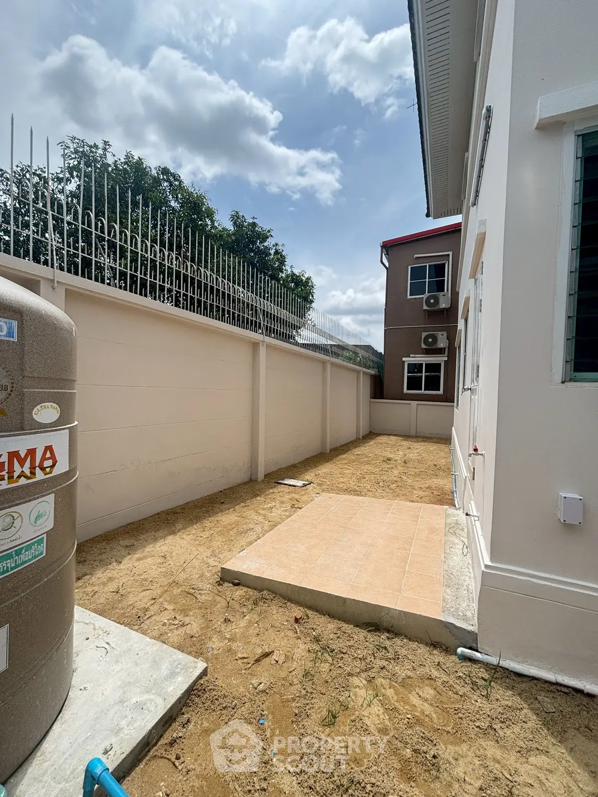 Spacious backyard area with potential for landscaping in a residential property.