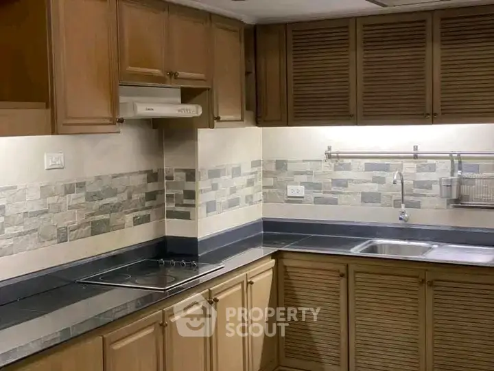 Spacious kitchen with modern cabinetry and sleek countertops in a stylish home.