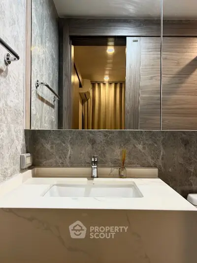 Modern bathroom with marble sink and stylish mirror