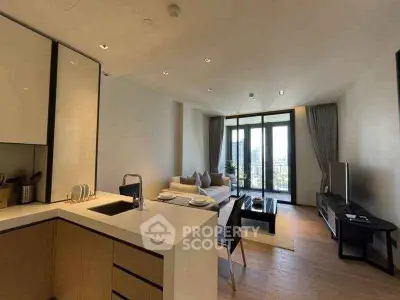 Modern open-plan living room with kitchen and large windows offering city views.