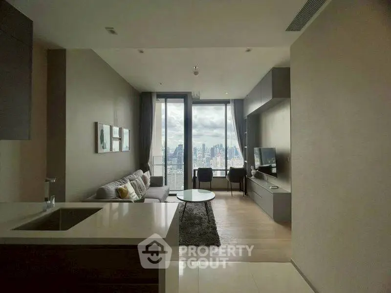 Modern living room with city view, sleek furniture, and open layout.