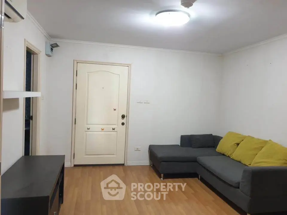 Cozy living room with modern gray sofa and wooden flooring