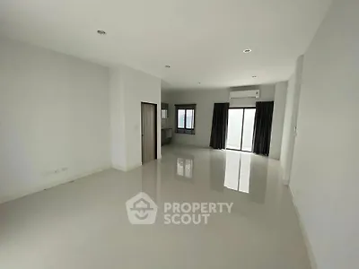 Spacious empty living room with large windows and modern flooring