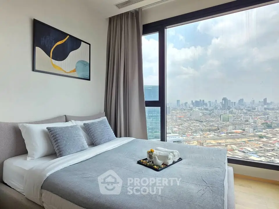Luxurious bedroom with stunning city view, modern decor, and cozy ambiance in high-rise apartment.