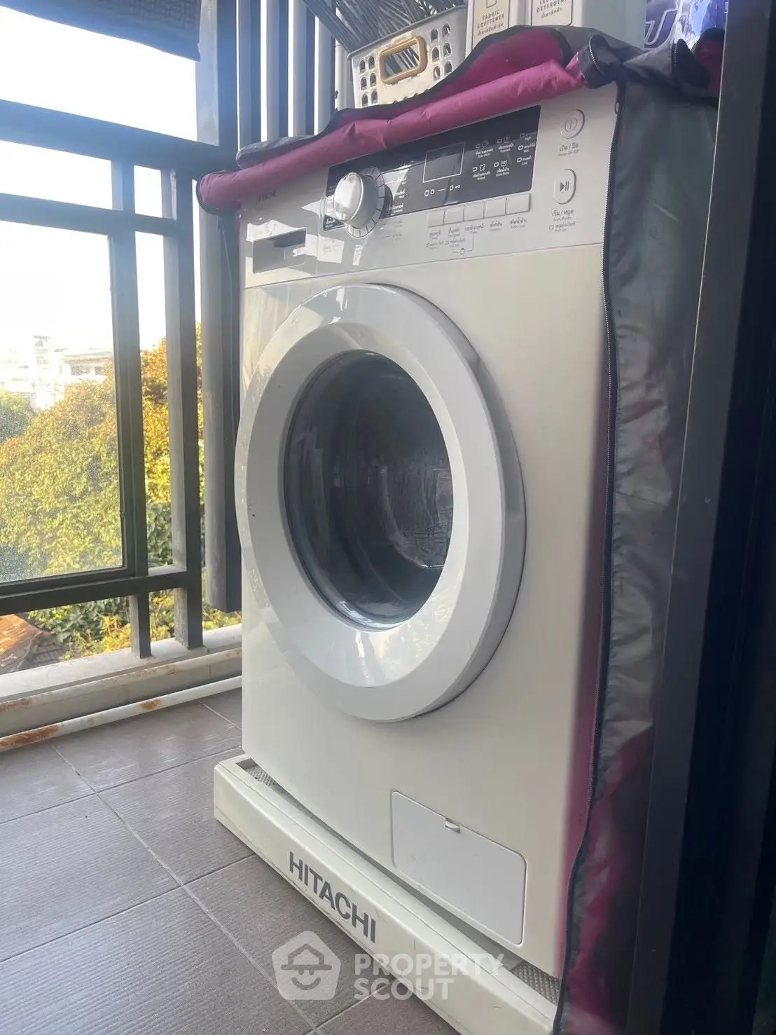 Modern washing machine on a balcony with a scenic view, perfect for urban living convenience.