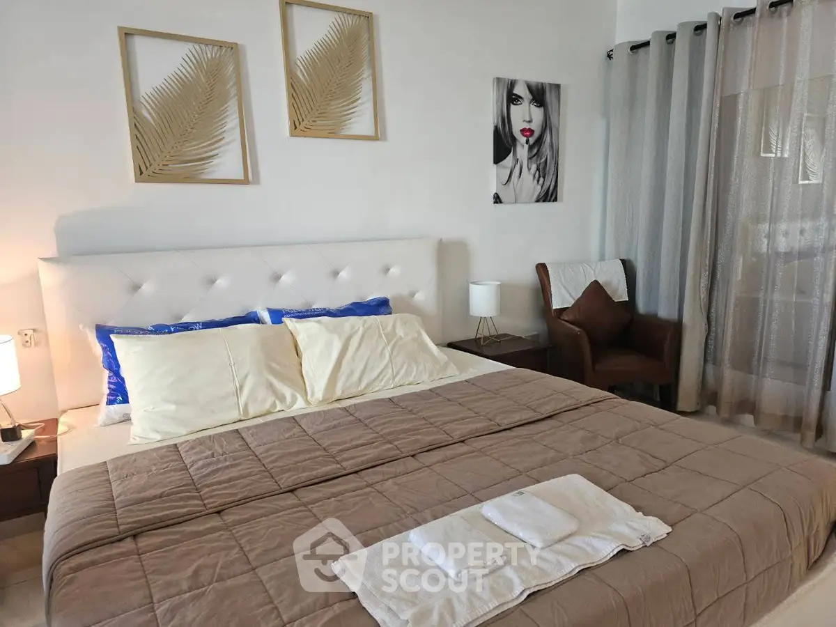 Elegant bedroom with modern decor and cozy ambiance, featuring stylish artwork and plush bedding.