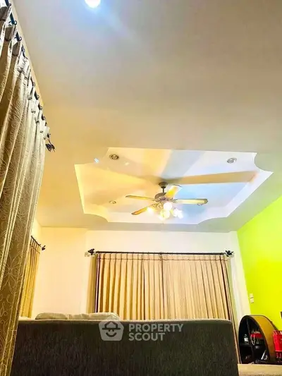 Spacious living room with elegant ceiling design and cozy ambiance.