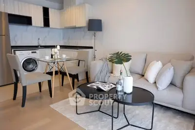 Modern open-plan living room with stylish kitchen and cozy seating area.