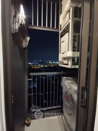 Cozy balcony with city night view, perfect for relaxation and enjoying the skyline.