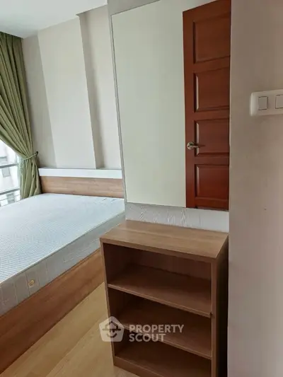 Modern bedroom with wooden furniture and large window for natural light