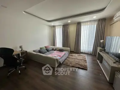 Spacious living room with modern decor and large windows for natural light.