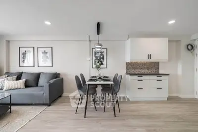 Modern open-plan living room with sleek kitchen and stylish dining area