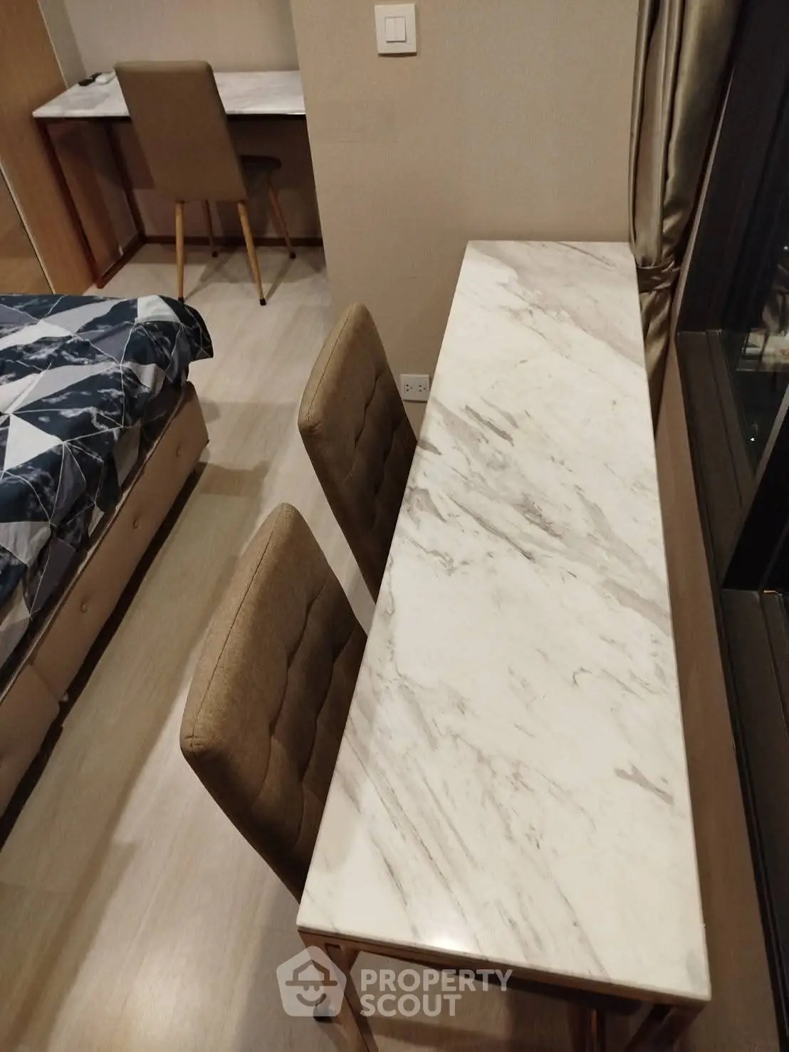 Modern bedroom with elegant marble desk and comfortable seating