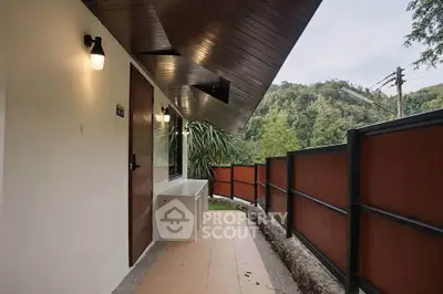 Charming outdoor balcony with scenic forest view, perfect for relaxation and enjoying nature.