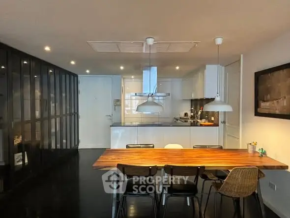 Modern kitchen with sleek dining area and stylish lighting