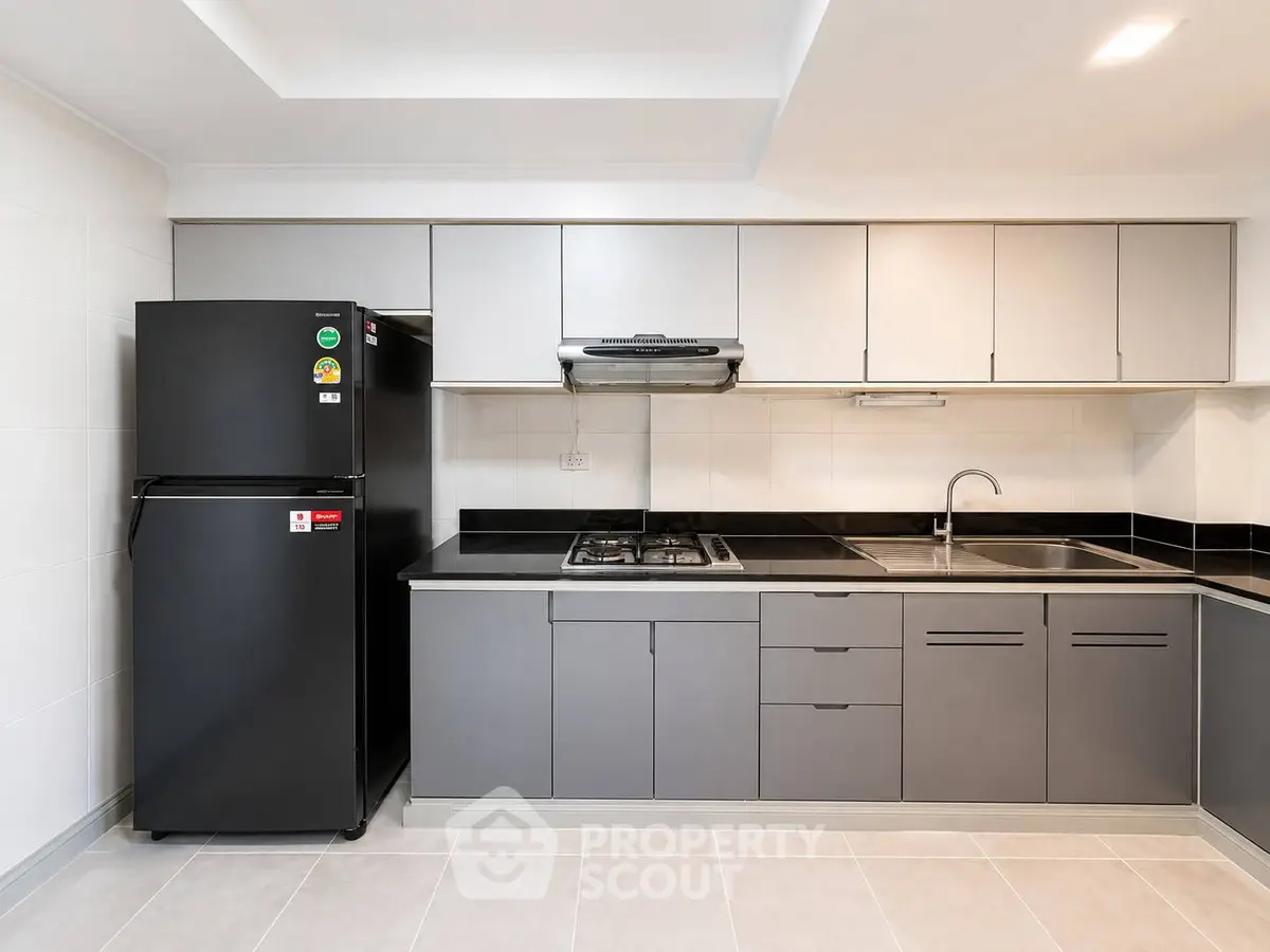 Modern kitchen with sleek cabinetry and gas stove in a contemporary apartment.