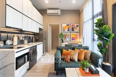 Modern open-plan living room and kitchen with stylish decor and natural light.