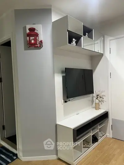 Modern living room with sleek TV unit and decorative shelving, perfect for stylish urban living.
